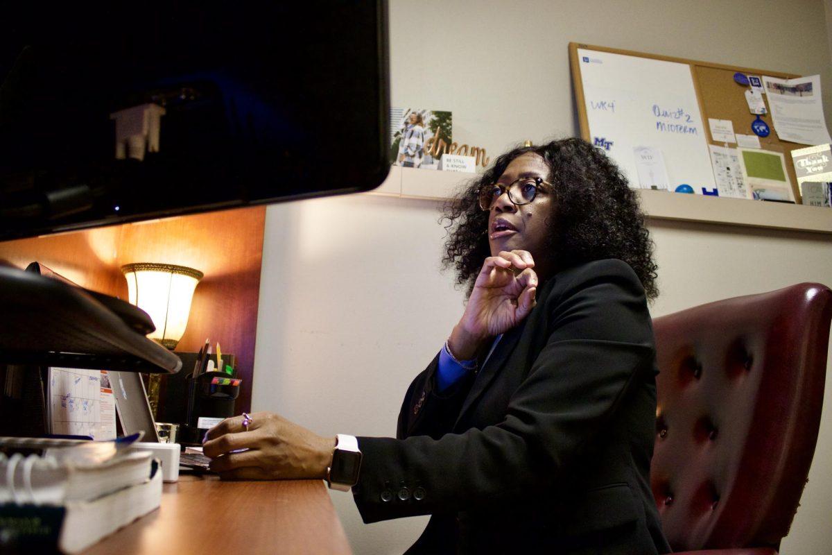 Professor Mytecia Myles multitasking at her desk in her office at MTSU in Murfreesboro, Tennessee, on Feb. 13, 2025.