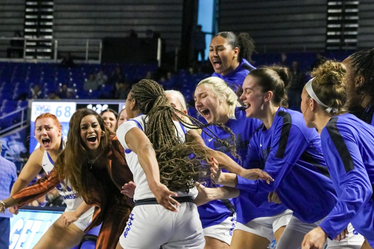 The MTSU bench celebrates with Courtney Blakely after an and-one play against Western Kentucky at the Murphy Center on Feb. 15, 2025.