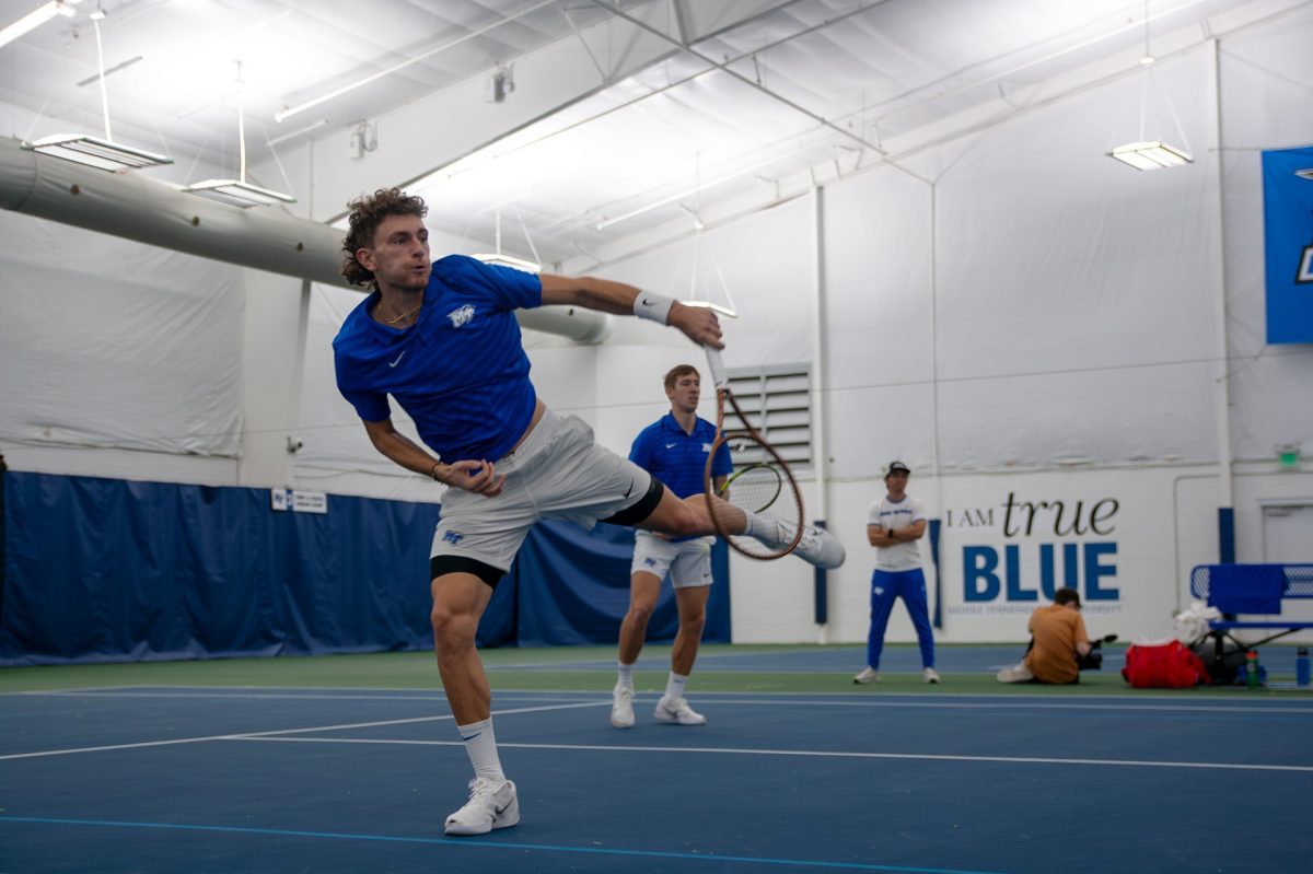 Karim Al-Amin contorts for a return against Arkansas at the Adams Tennis Complex on Feb. 9, 2025.
