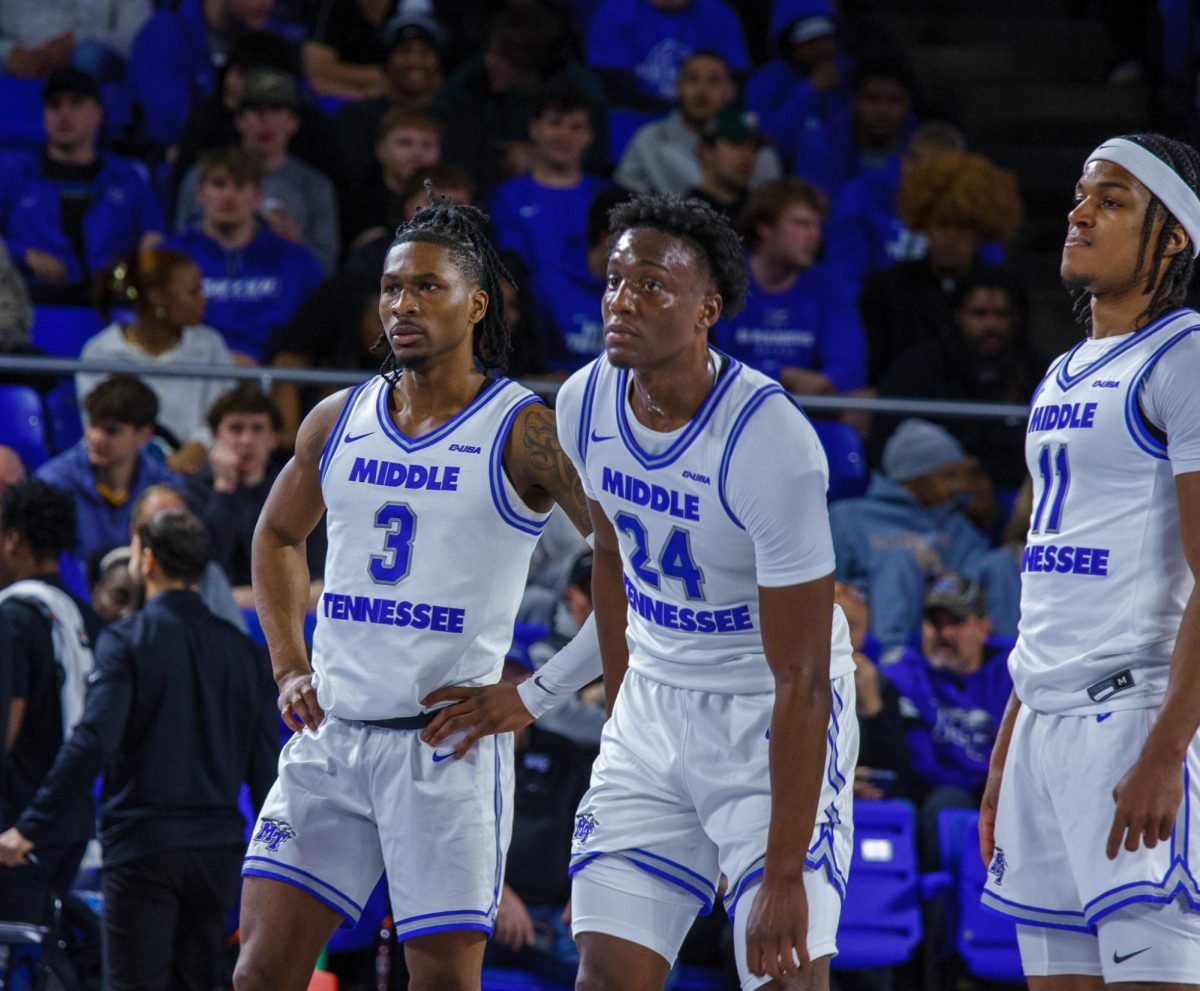 Jestin Porter, Camryn Weston and Tre Green during a timeout against Liberty on March 6, 2025