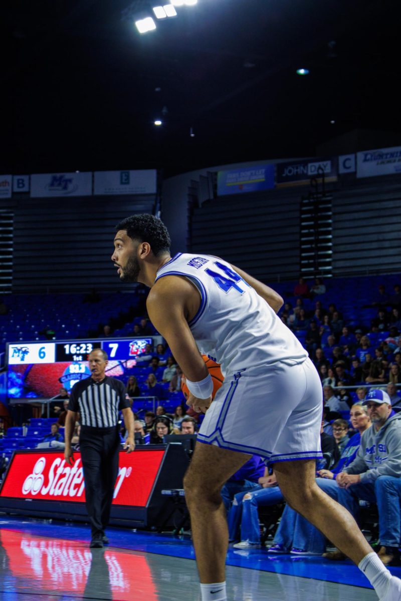 Forward Essam Mostafa looks to make a move against Liberty at the Murphy Center on March 6, 2025.