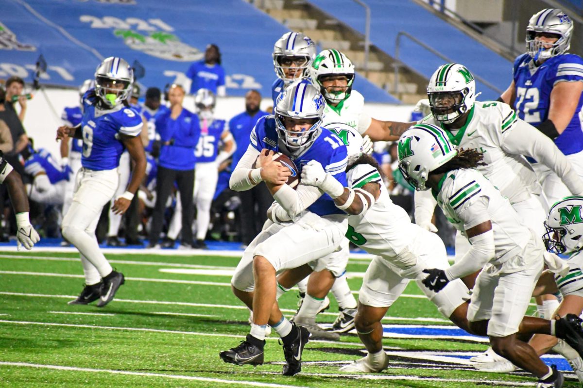 MTSU's Nick Vattiato scrambles as a pack of Marshall defenders are in pursuit, at Floyd Stadium on Sept. 20, 2025.