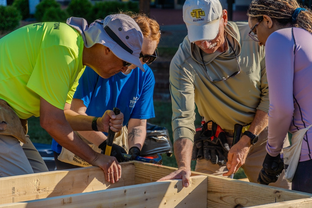Volunteers assist putting a house frame together for a Habitat for Humanity event on campus on Oct. 2, 2025, in the Student Union Commons.
