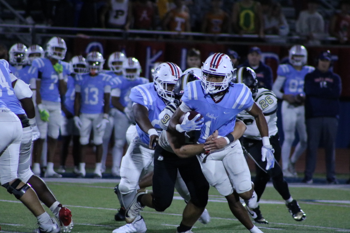 Oakland High School's Craig Tutt drags a Bradley Central defender during a game at Ray Hughes Stadium, Nov. 16, 2025.