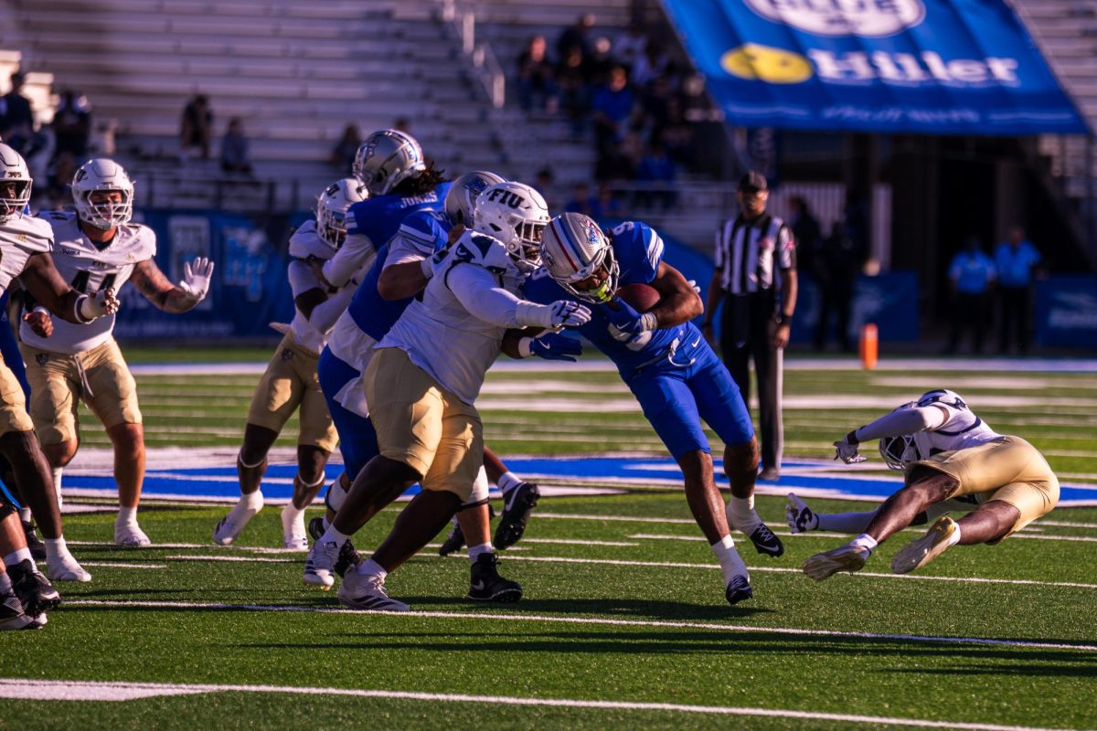 MTSU running back Jekail Middlebrook fights through a tackle in a game against FIU at Floyd Stadium on Nov. 8, 2025.