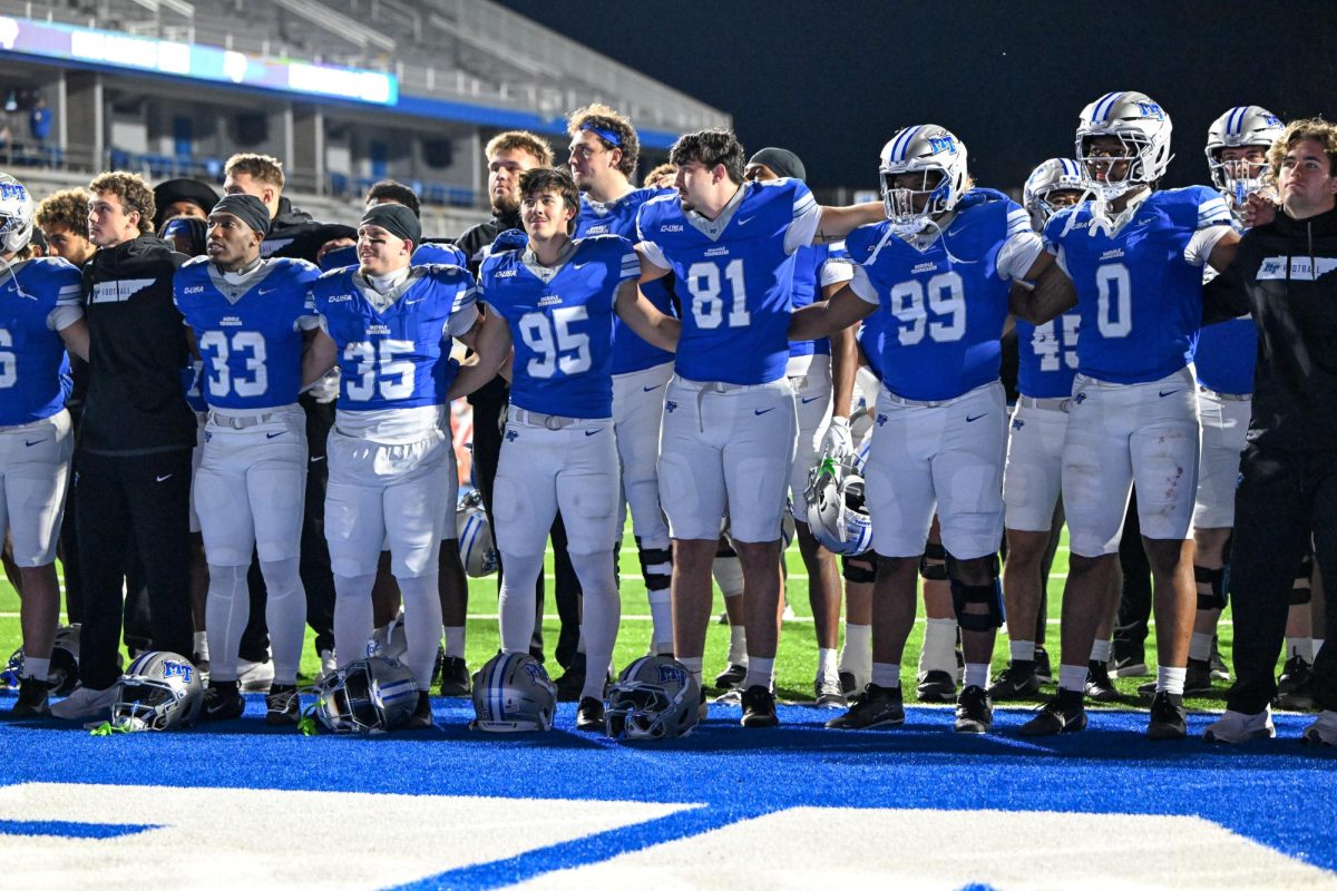 MTSU players lock arms during the MTSU alma mater after a game against Sam Houston, at Floyd Stadium on Nov. 22, 2025 