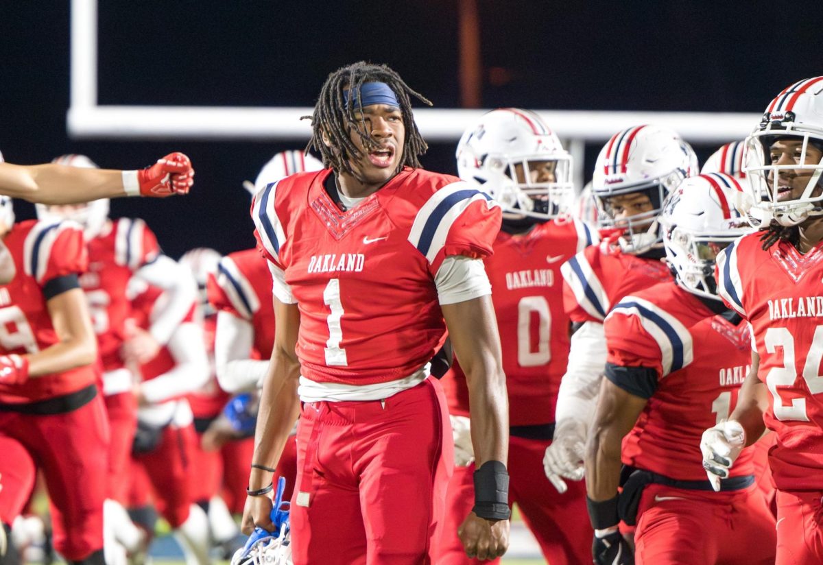 Oakland High School’s Craig Tutt looks at Blackman High School’s sideline during pregame run outs before a game at Ray Hughes Stadium, on Nov. 28, 2025. 