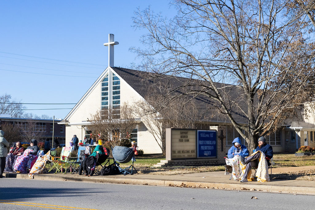 Parade goers await the start of the Murfreesboro Christmas Parade on E Main St. as Members of the First Cumberland Presbyterian Church pass out free hot coco on Dec. 14, 2025 