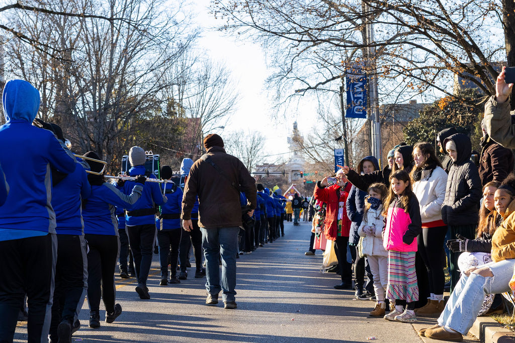 Parade goers watch as the Rockvale Highschool band plays in the Murfreesboro Christmas Parade on E Main St. on Dec. 14, 2025 