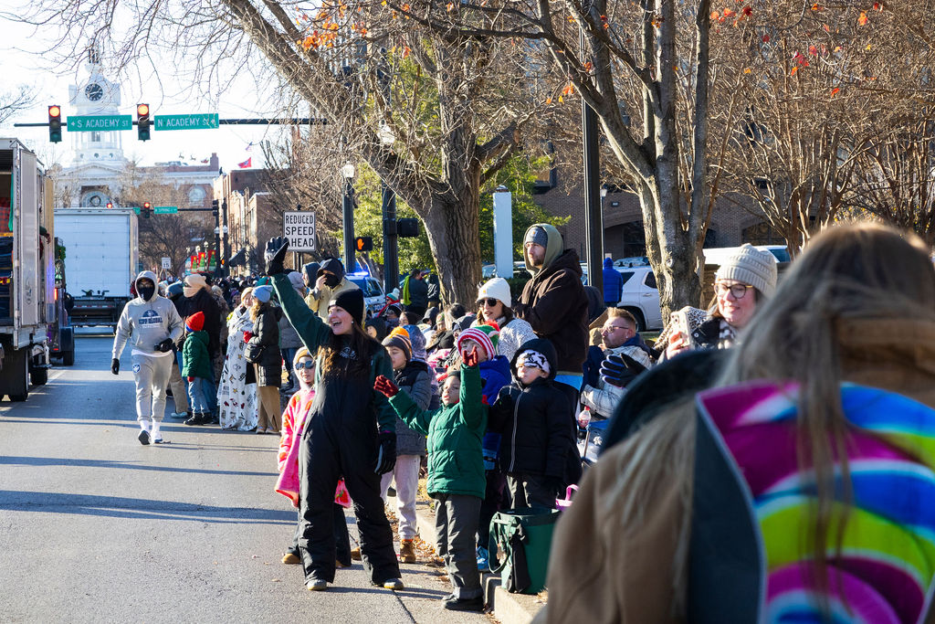 Families wave and cheer on the parade as it enters the square of Murfreesboro during the Murfreesboro Christmas Parade on E Main St. on Dec. 14, 2025 

 