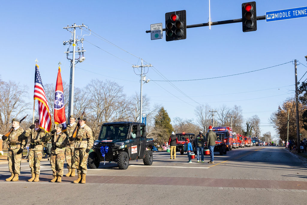 Oakland Highschool JRTOC Cadets (left to right) Cadet Second Lieutenant Colver Jones, Cadet Lieutenant Colonel Kenzie McCoy, Cadet Major Raquel Hernandez, Cadet First Lieutenant Charlie Goodson, at the command of Cadet Command Sergeant Major Hatton Kerr wait a helicopter fly over to start the Murfreesboro Christmas Parade on E Main St. on Dec. 14, 2025 