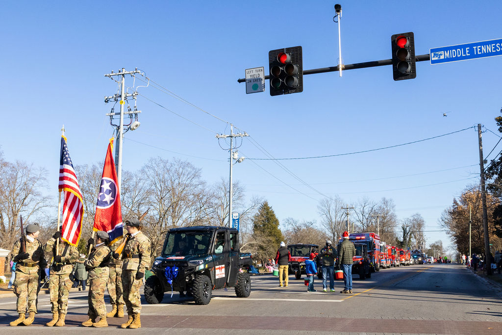 Oakland Highschool JRTOC Cadets (left to right) Cadet Second Lieutenant Colver Jones, Cadet Lieutenant Colonel Kenzie McCoy, Cadet Major Raquel Hernandez, Cadet First Lieutenant Charlie Goodson, at the command of Cadet Command Sergeant Major Hatton Kerr view their helicopter fly over at the Murfreesboro Christmas Parade on E Main St. on Dec. 14, 2025 

