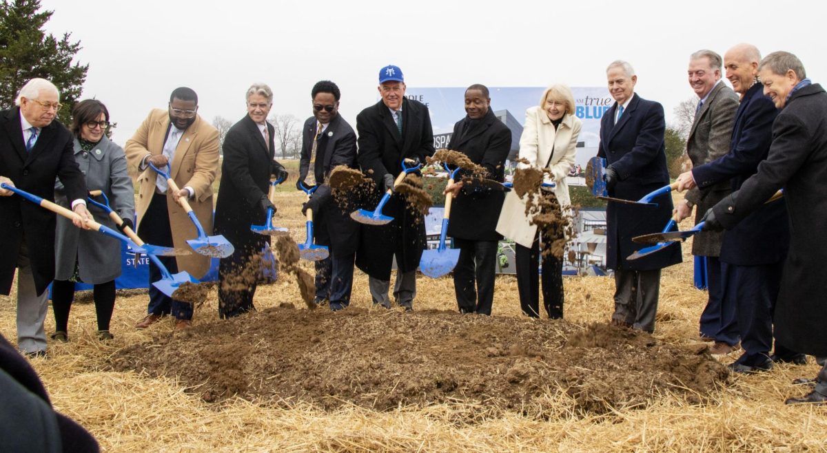 Members of MTSU's Board of Trustees and others ceremoniously throw dirt at the Shelbyville Municipal Airport on Dec. 2, 2025.
