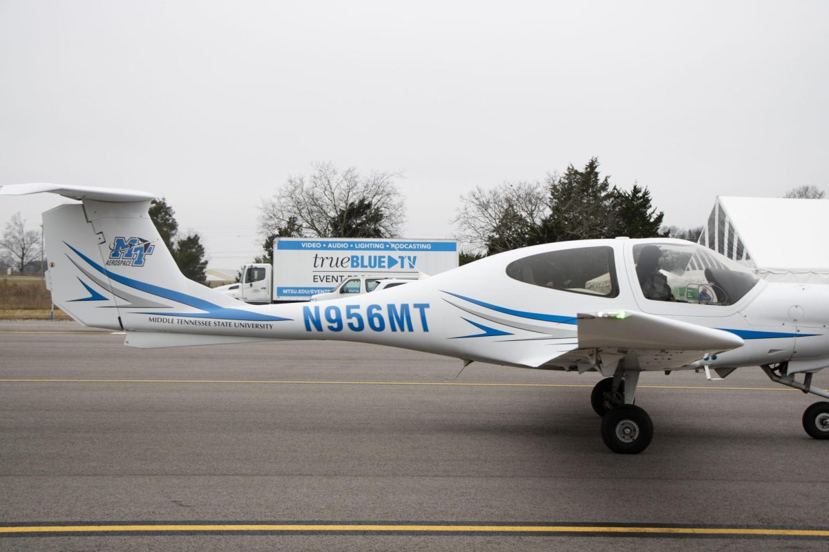 An airplane taxis down the runway at the Shelbyville Municipal Airport on Dec. 2, 2025, giving way to a view of the True Blue TV truck.