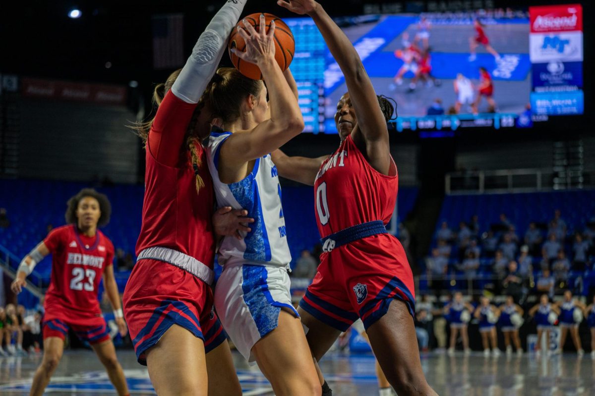 MTSU's Blair Baugus looks to get out of a trap by Belmont defenders during a game at the Murphy Center on Dec. 3, 2025.