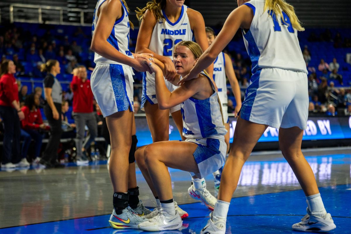 MTSU players help up teammate Kirston Verhulst during a game against Belmont at the Murphy Center on Dec. 3, 2025.