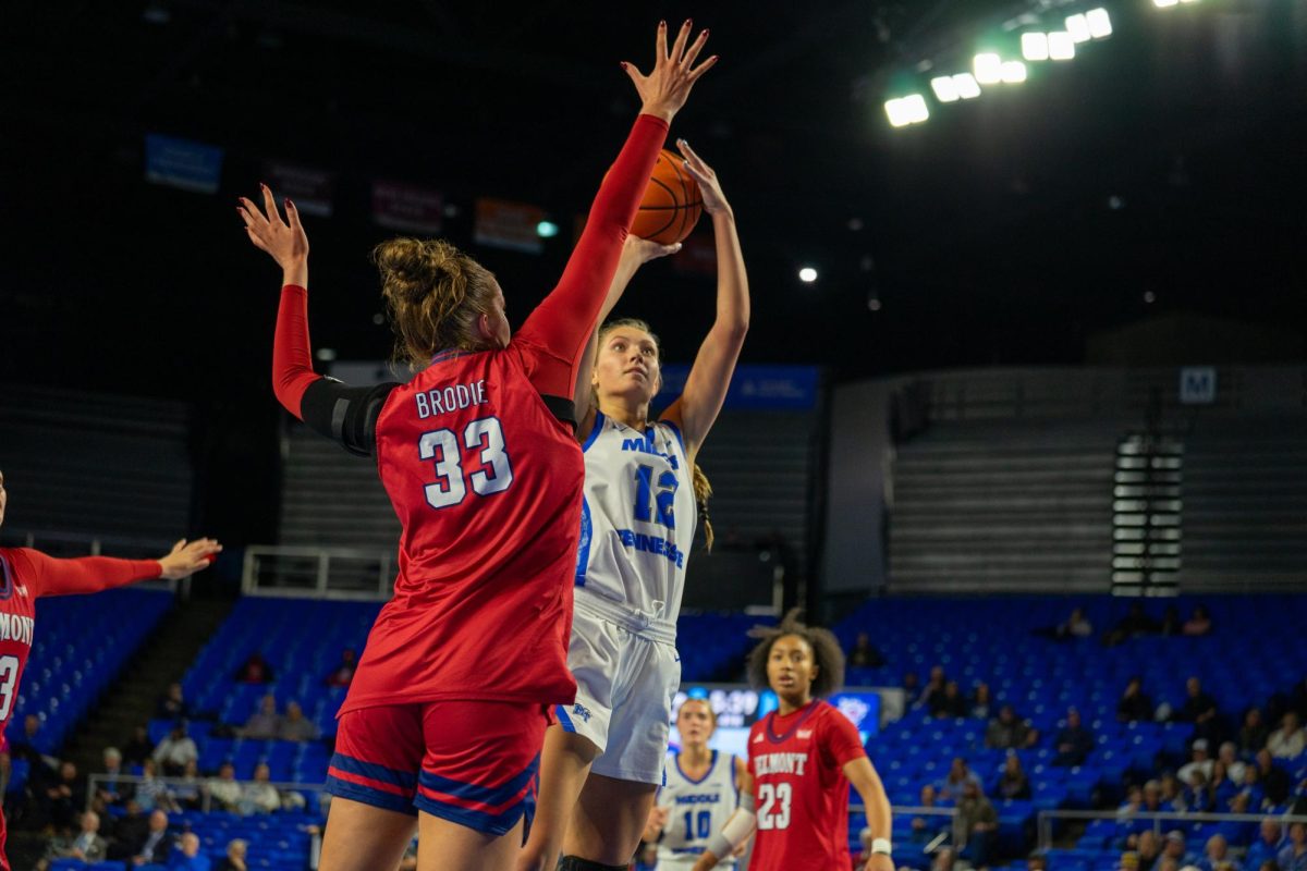 MTSU's Blair Baugus shoots a jumpshot over Belmont's KK Brodie during a game at the Murphy Center on Dec. 3, 2025.