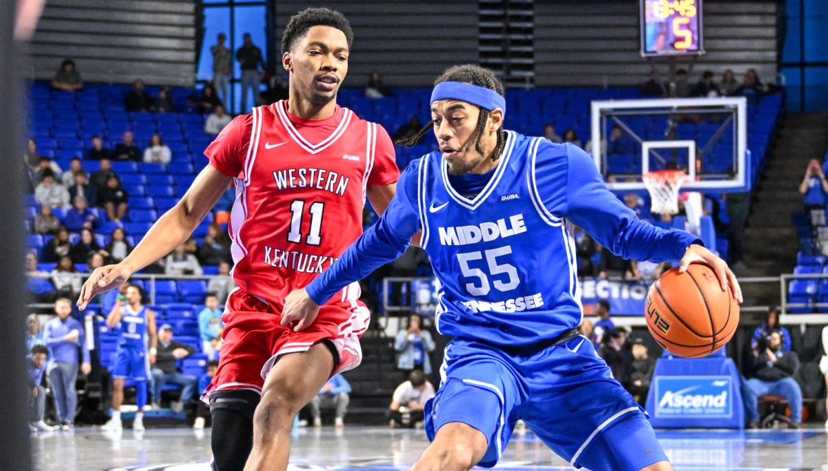 MTSU guard Sean Smith (right) dribbles past WKU guard Terrion Murdix (left) during a game against Western Kentucky, inside the Murphy Center on Jan. 31, 2026.