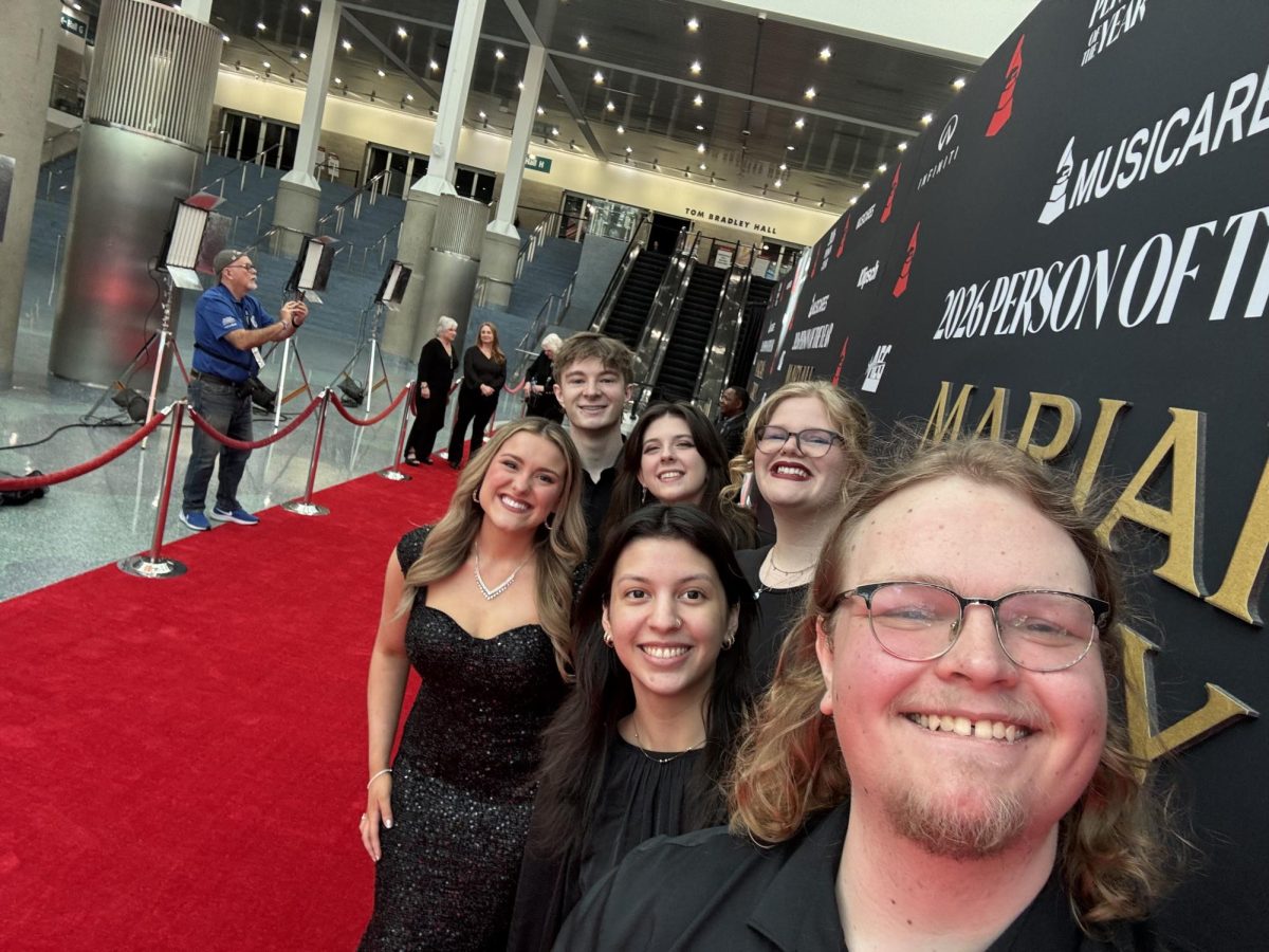(Front left to right: Emily Eastep, Gabriela Diaz, Chandler Furr; back left to right: Colman Connolly, Anna Shinholster, Jenene Grover) Students pose for photos on the red carpet at the MusiCares Person of the Year Gala at the Los Angeles Convention Center on Jan. 30, 2026.
