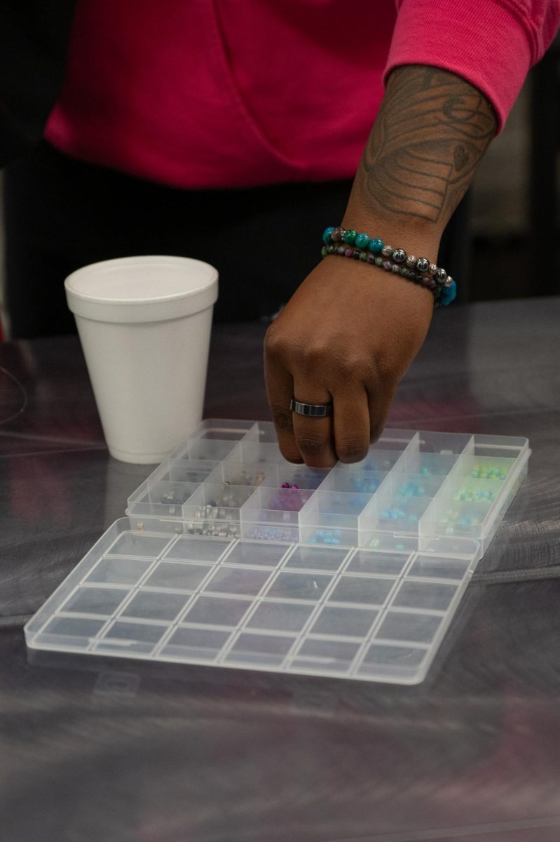 Students select beads during a waist bead-making event at the Student Union Building, Feb. 18, 2026.