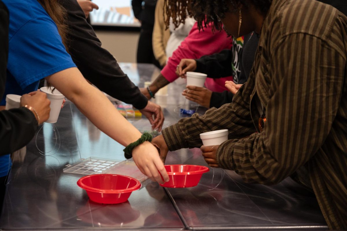 Students select beads during a waist bead-making event at the Student Union Building, Feb. 18, 2026.