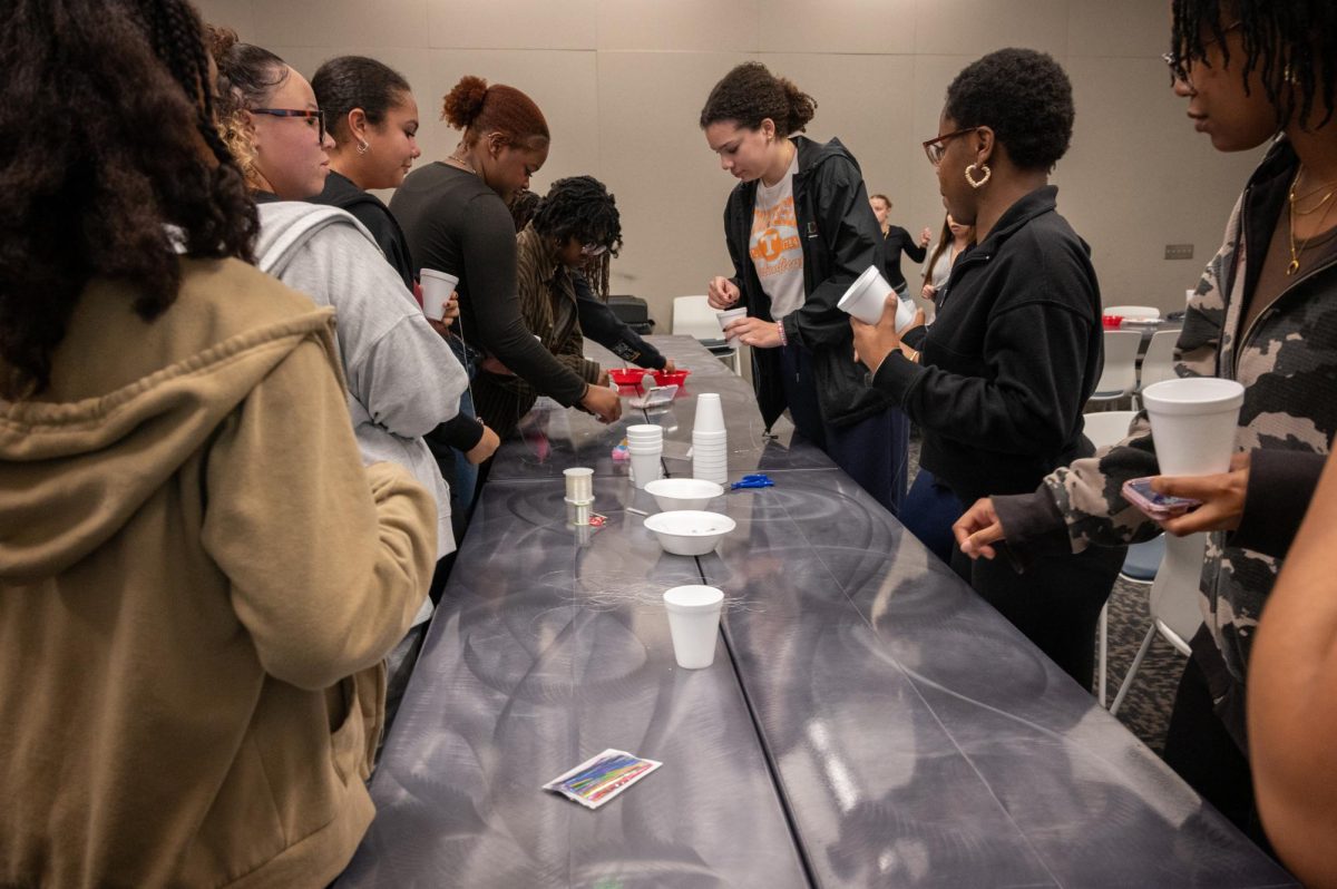 Students choose materials for waist beads at the Student Union Building, Feb. 18, 2026.