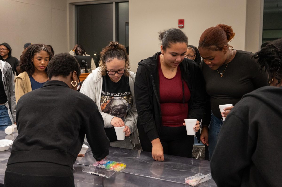 Students choose materials for waist beads at the Student Union Building, Feb. 18, 2026.