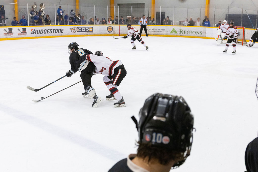 MTSU captain Linden Palmer is jostled off the puck by a USC defender during a game against South Carolina, on Feb. 6, 2026, inside the Ford Ice Hockey Center in Antioch, Tennessee. 
