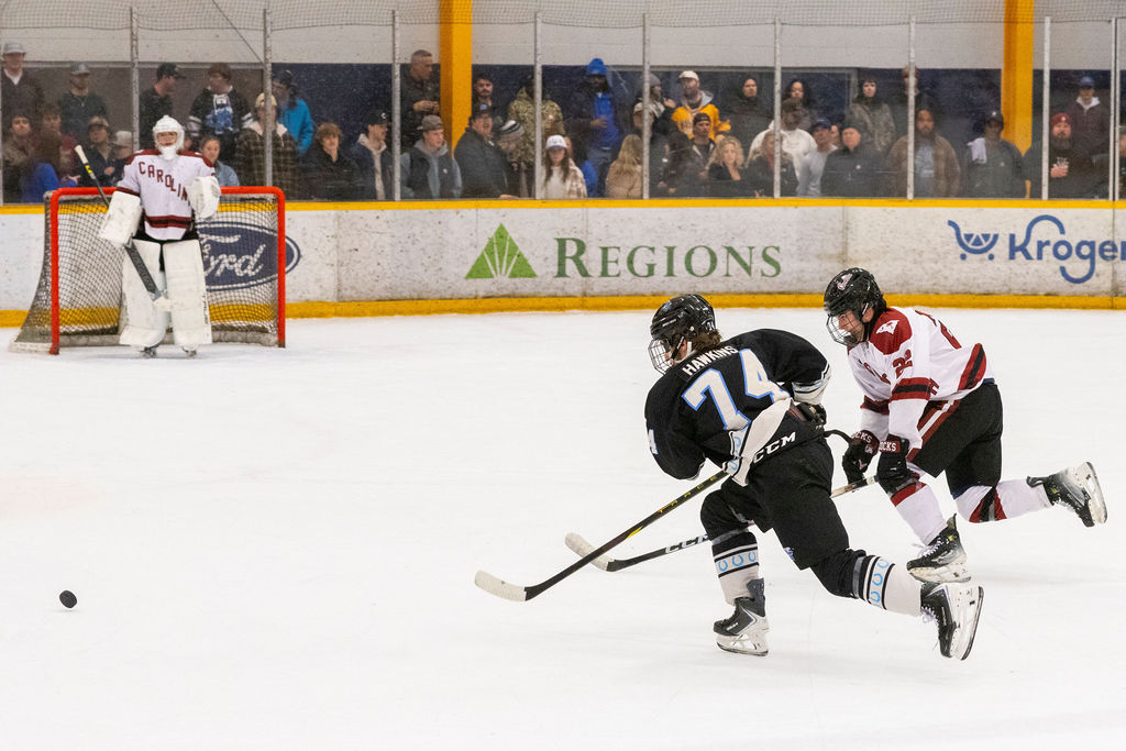 MTSU forward Cam Hawkins (left) and USC defenseman Anthony Minosse (right) chase after a puck dumped into the zone during a game against South Carolina, on Feb. 7, 2026, inside the Ford Ice Hockey Center in Antioch, Tennessee. 
