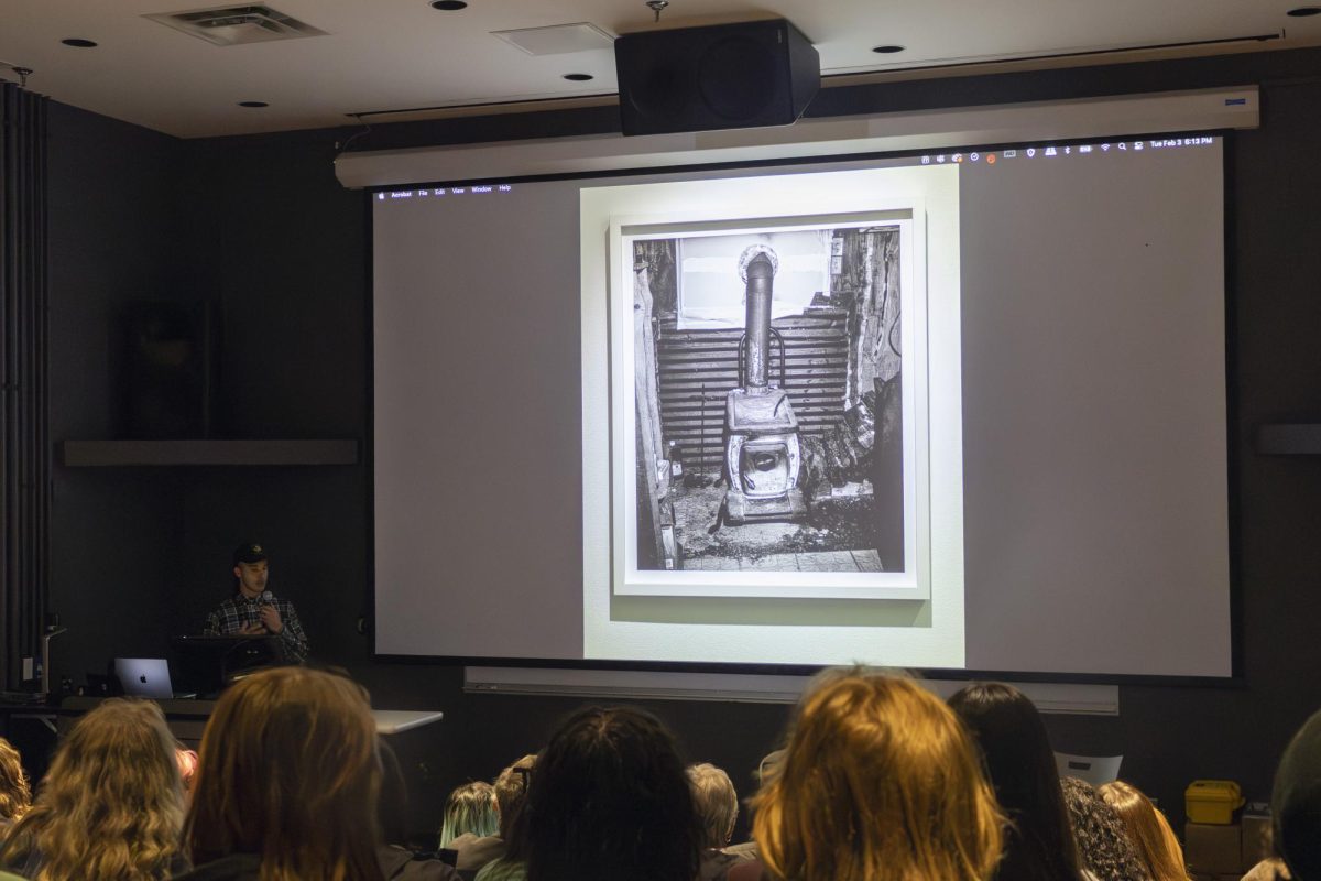Rahim Fortune speaking at an artist talk about one of his photos. 