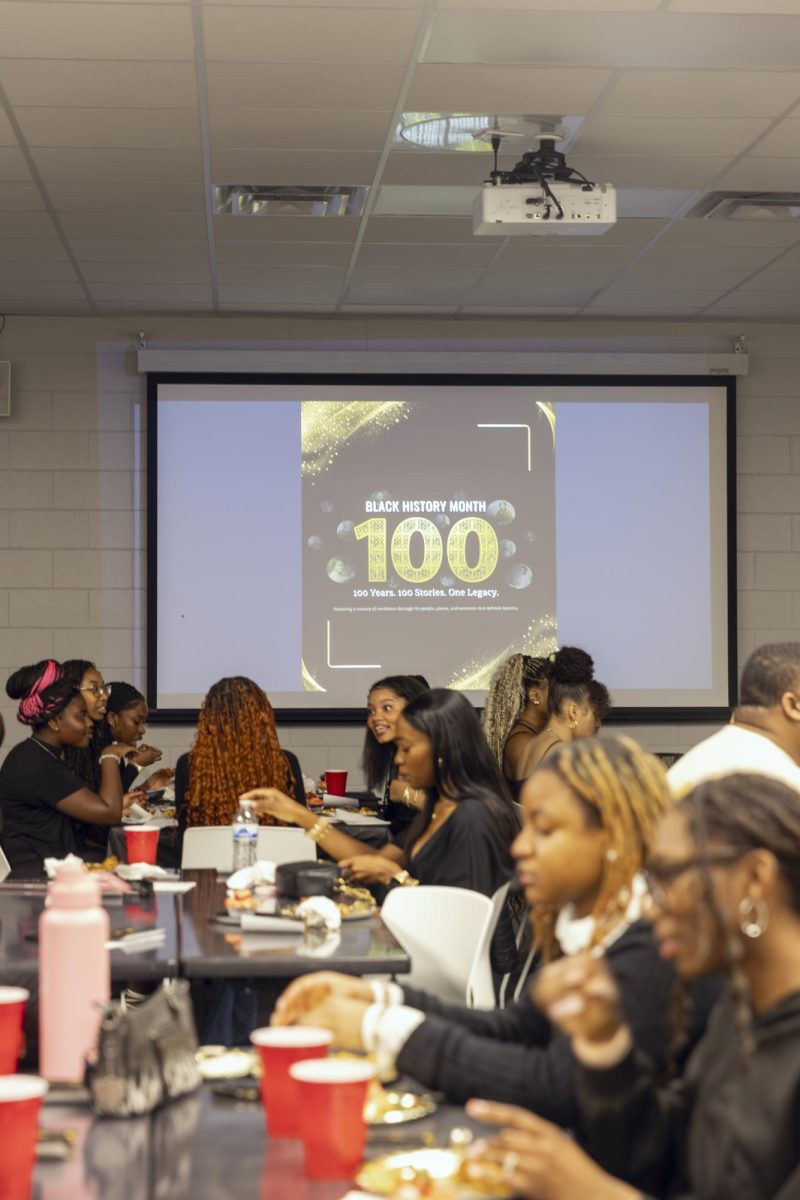 A student eats and talks with a Black History flyer in the background during the Seat at the Table event on Feb. 10, 2026. 