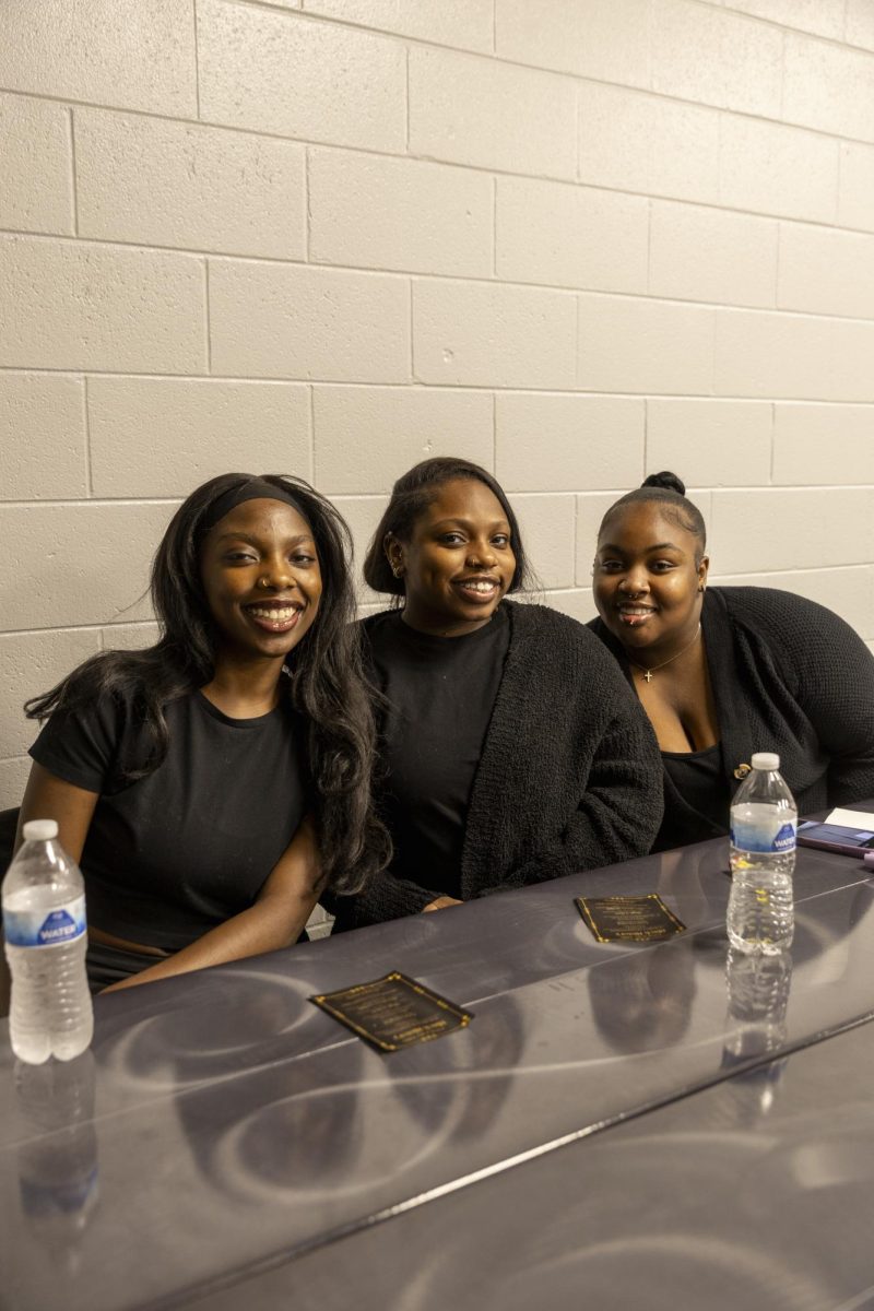 Carmen Hopkins, TeRiyon Williams and Micajah Wilder pose for a photo at a table during the Seat at the Table Black History event on Feb. 10, 2026. 