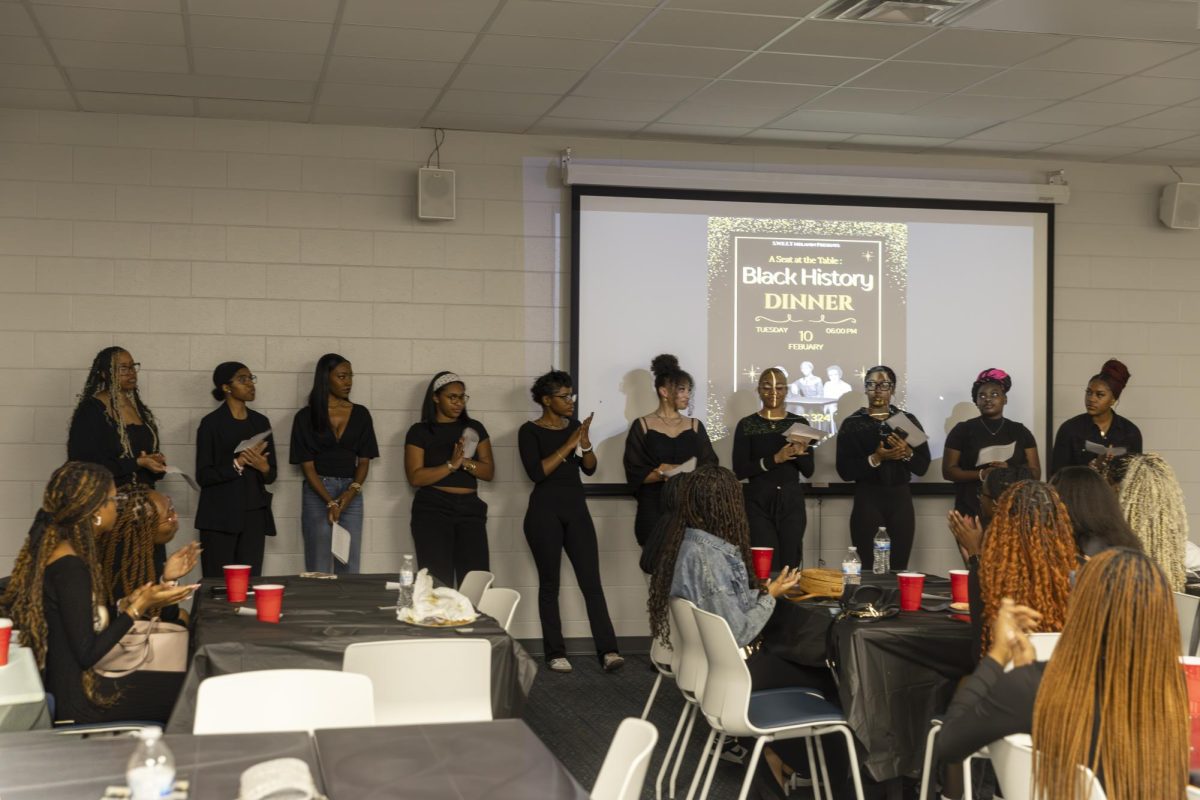 Attendees clap after hearing fun facts during the Seat at the Table Black History event on Feb. 10, 2026.