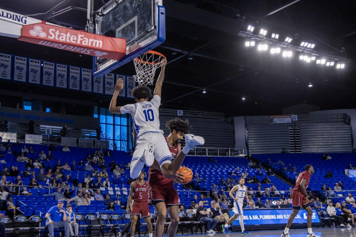MTSU forward Torey Alston dunks against New Mexico State forward Julius Mims inside the Murphy Center on Feb. 28, 2026.