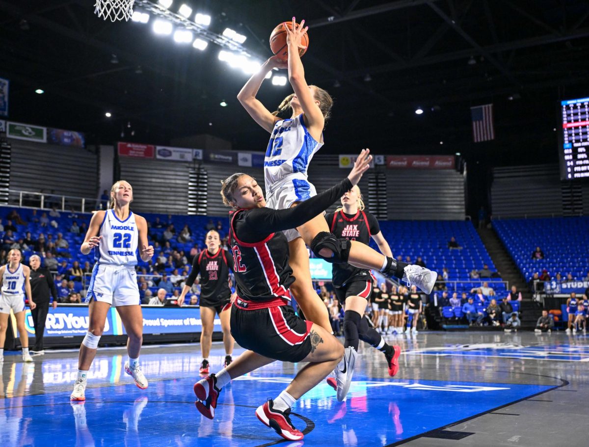 MTSU guard Blair Baugus (right) drives in the lane while Gamecock forward Mya Barnes (left) tries to draw a charge during a game against Jacksonville State, inside the Murphy Center on Feb. 12, 2026.