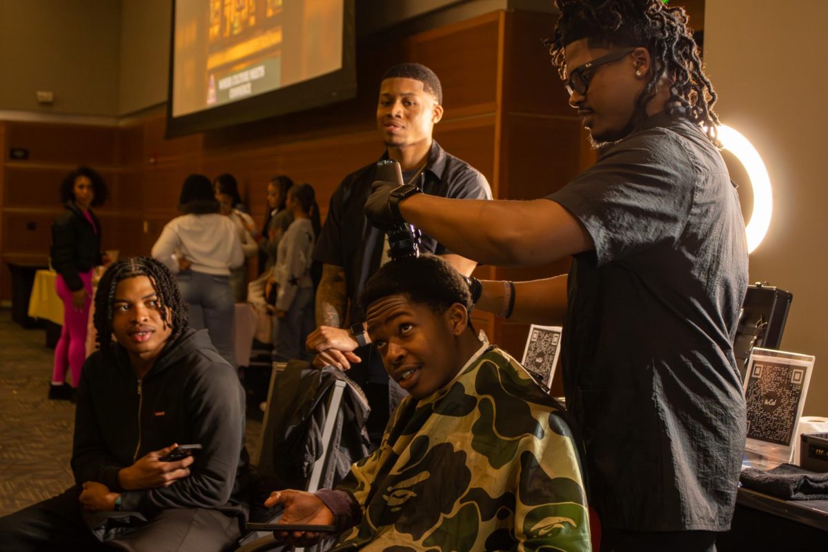 Men talk while cutting hair during the Black Culture Showcase at MTSU, on Feb. 23, 2026.