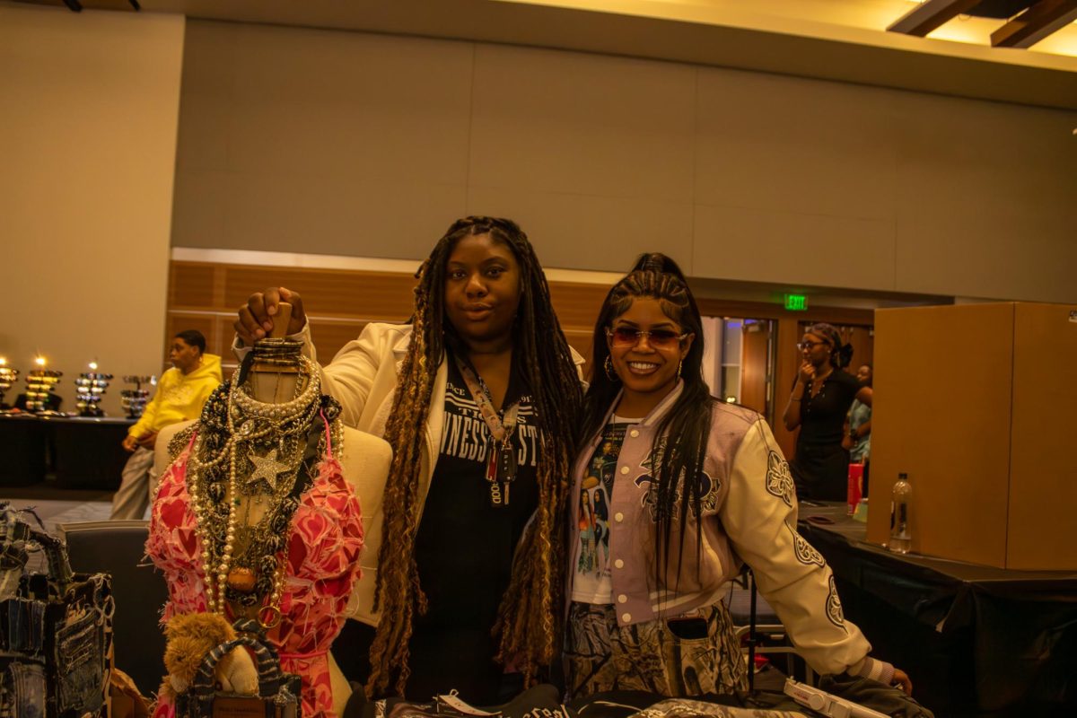Jimmyy Vee and B3 Boutique stand behind their table selling handcrafted clothing during the Black Culture Showcase at MTSU on Feb. 23, 2026.