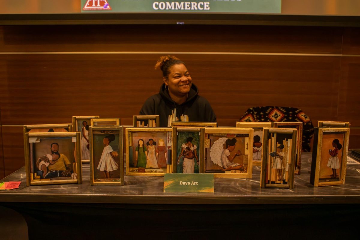 Dayo Johnson sits at the table displaying art at the Black Culture Showcase at MTSU on Feb. 23, 2026.