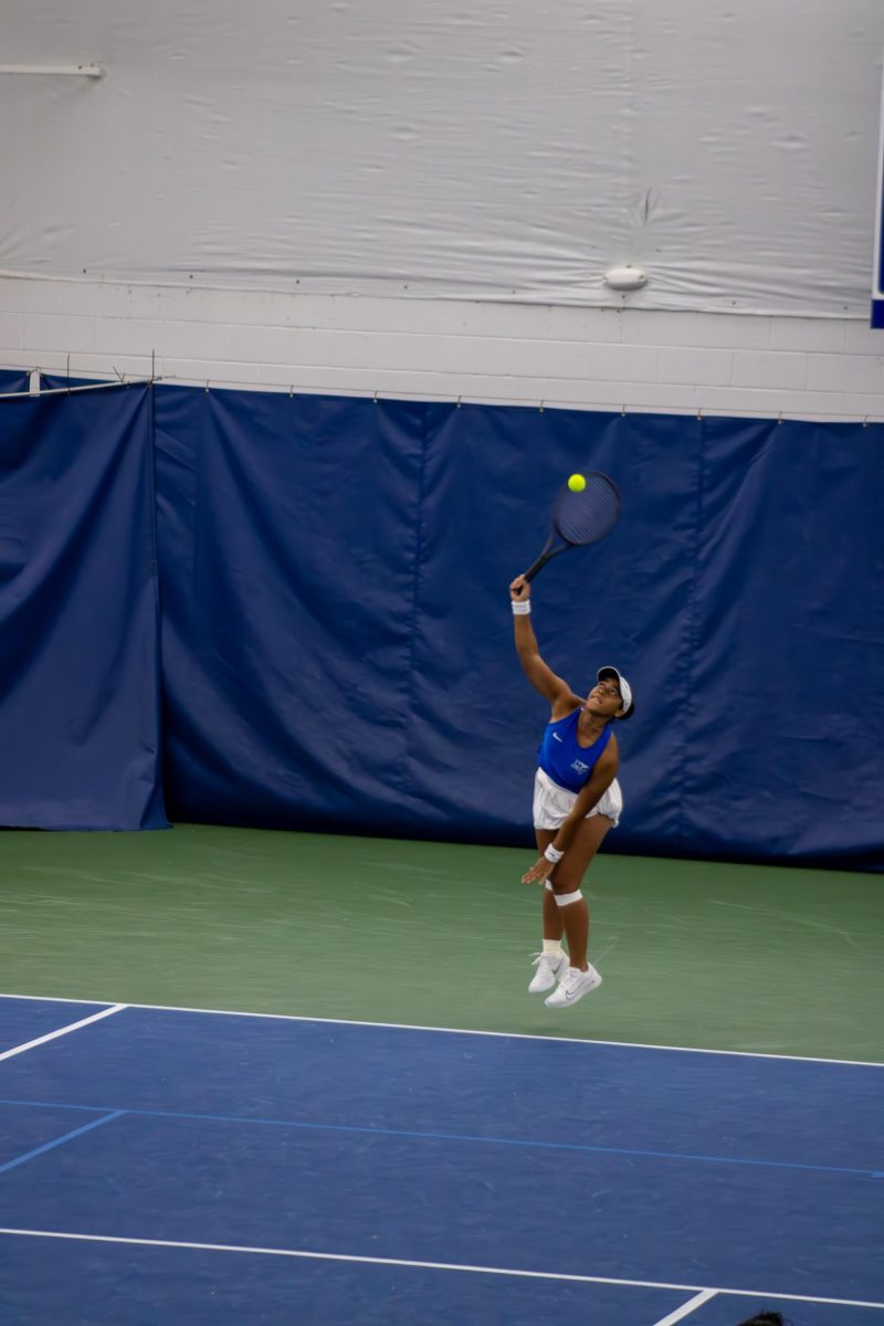 Sthefany Lima at the top of serve against Northwestern University at the Adams Tennis Complex on Jan. 31, 2026. 