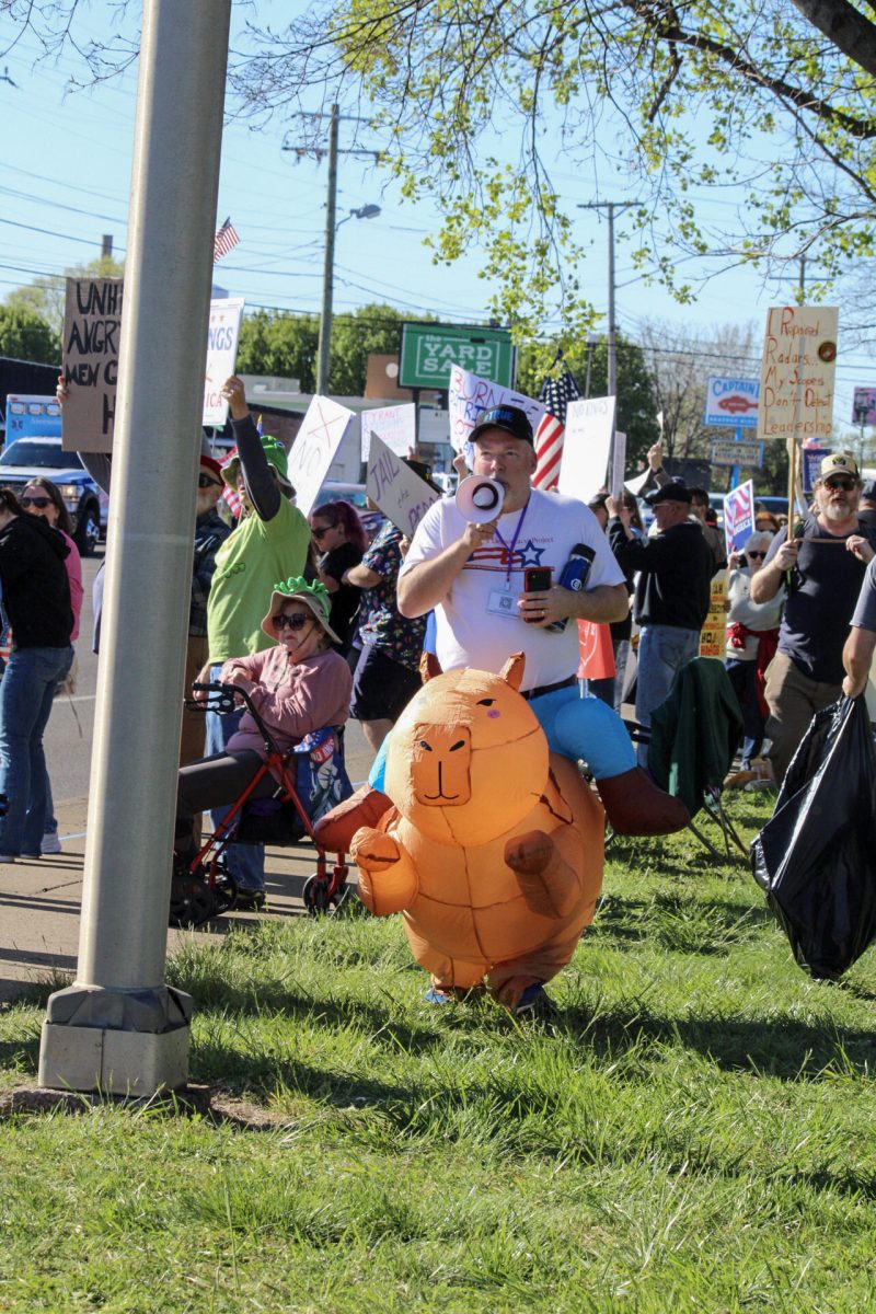 A protester leads chants through a megaphone on Broad Street at the "No Kings" protest in Murfreesboro, Tennessee, on March 28, 2026.