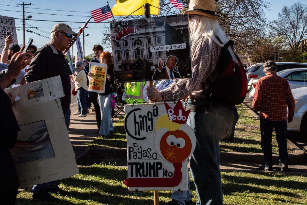 A protester holds a sign that reads "Trump did that!" at a "No Kings" protest in Murfreesboro, Tennessee, on March 28, 2026.