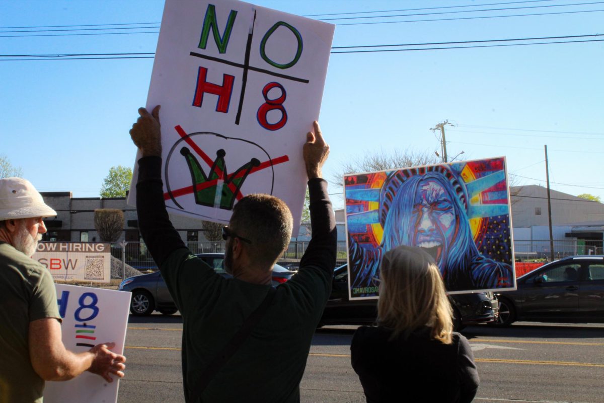 Protesters demonstrate with colorful picket signs along Broad Street in Murfreesboro, Tennessee, on March 28, 2026.