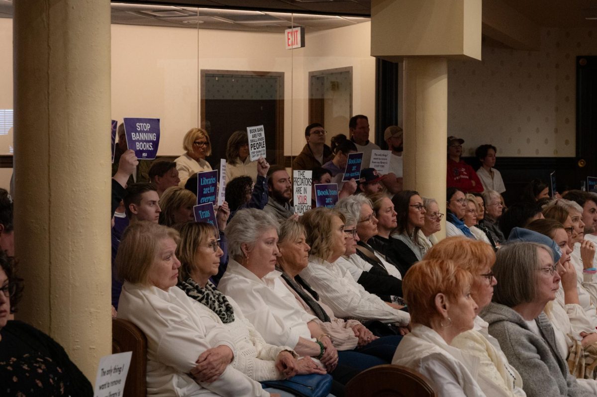 Protesters hold signs during a Rutherford County Library System board meeting at the Rutherford County Courthouse on March 16, 2026. 