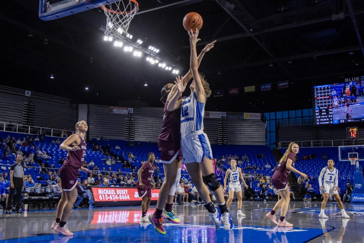 MTSU guard Blair Baugus shooting around a Missouri State player in the Murphy Center on March 7, 2026.