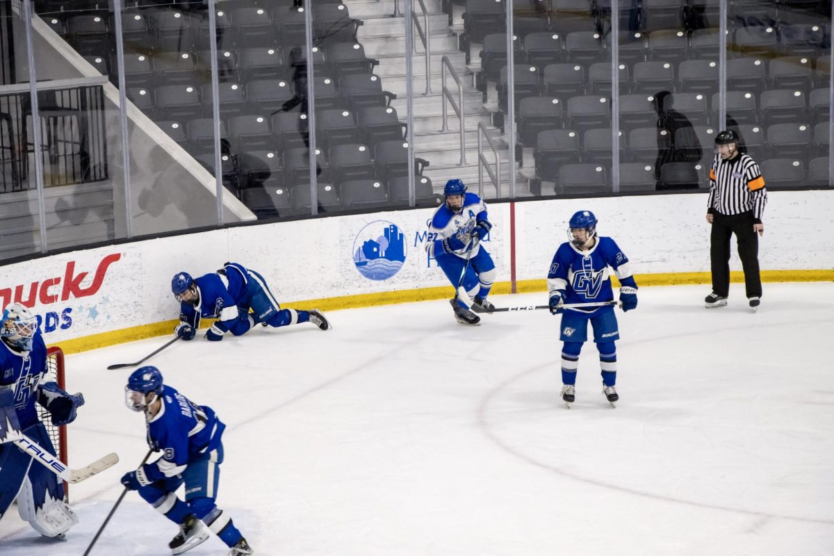 MTSU club hockey forward Matthew Siciliano looking for the puck in a crowd of Grand Valley State players during a game at the Centene Community Ice Center on March 20, 2026.