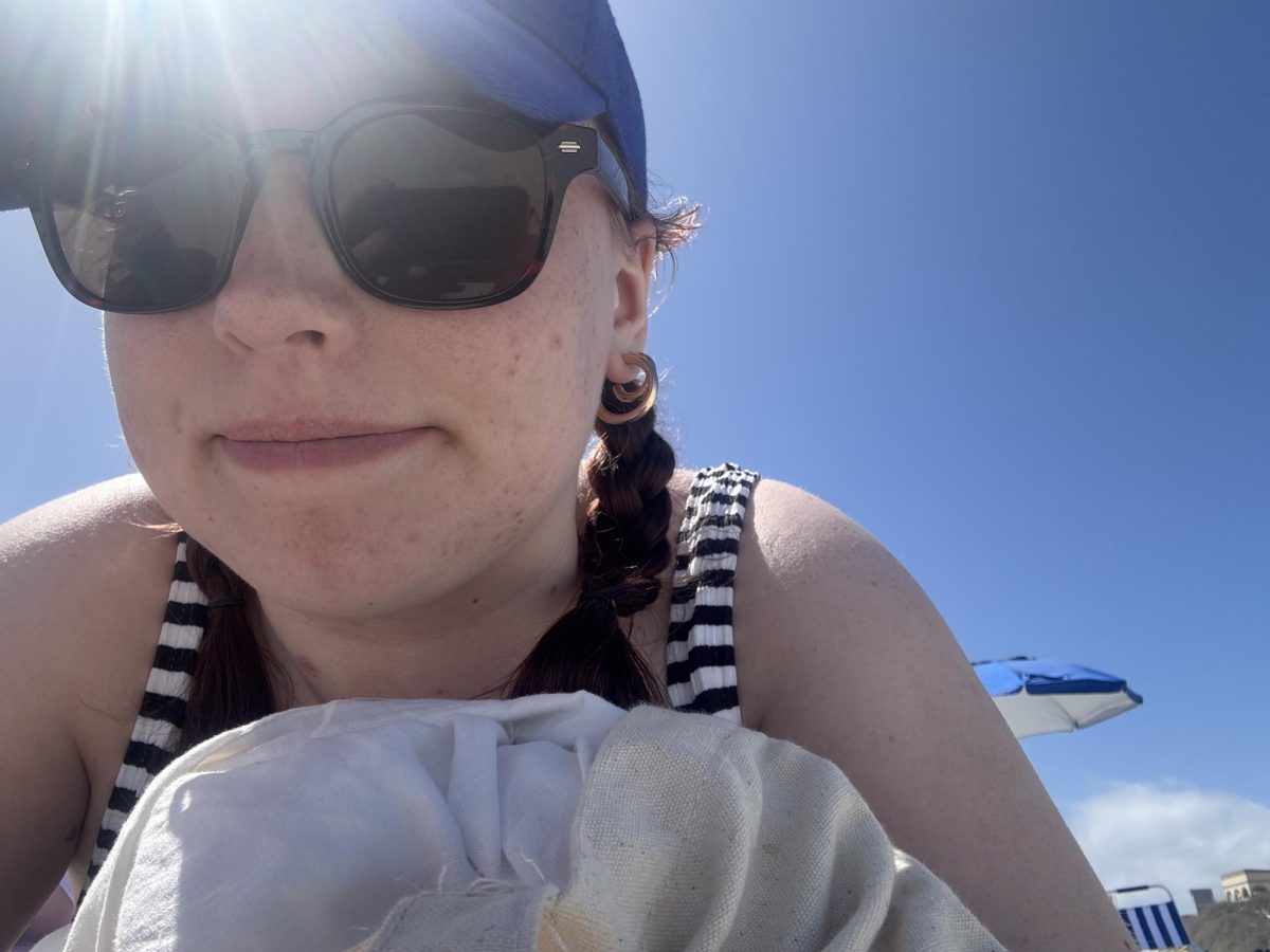 Olivia Summers actively getting sunburnt on the beach in Florida on March 2026.
