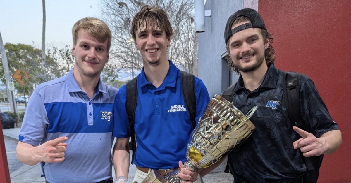 MTSU club president Zach Giblin (right), MTSU goaltender Ayden Kopec (middle) and MTSU goaltender Grant Williams (left) pose with the College Hockey South Conference championship trophy. 