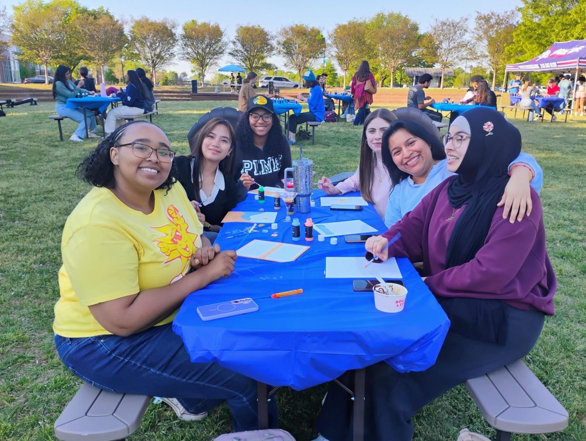 A group of students paint canvas' on the Student Union Commons at Picnic 'n Painting on April 7, 2026.