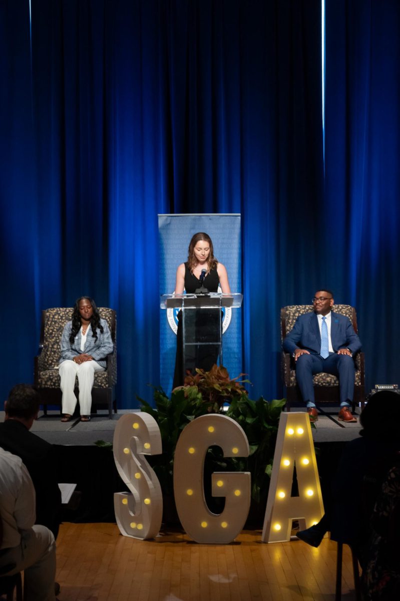 Homecoming Director Sydney Barnett speaks to the audience at the SGA
inauguration in the James Union Building on Apr. 23, 2026.