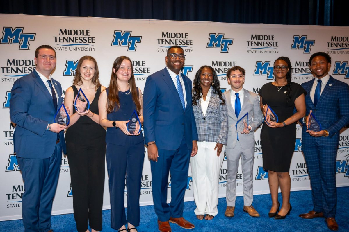 The Former SGA Executive Board holds up their awards at the SGA inauguration in the James Union Building on Apr. 23, 2026.